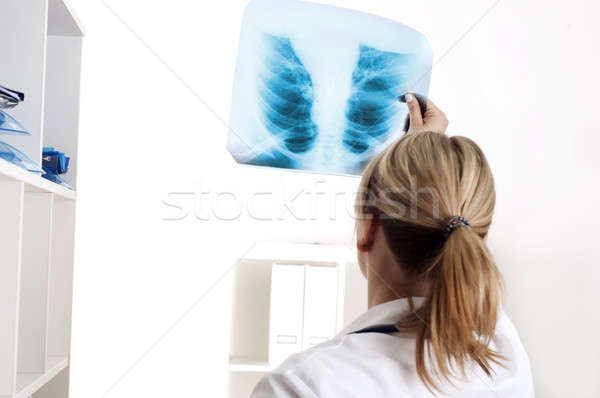 Female medic looking at x-rays Stock photo © adam121