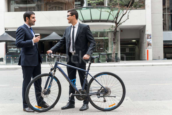 Сток-фото: два · бизнесменов · ходьбы · говорить · ходьбе · велосипед