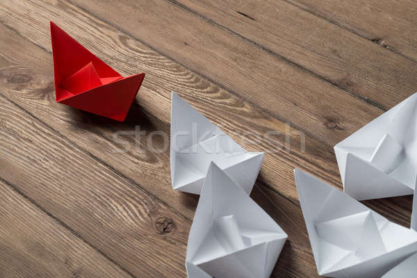 Business leadership concept with white and color paper boats on wooden table Stock photo © adam121