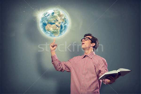 Stock photo: young man with a book thinks