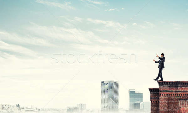 Danger and risk concept with businessman making step from edge Stock photo © adam121