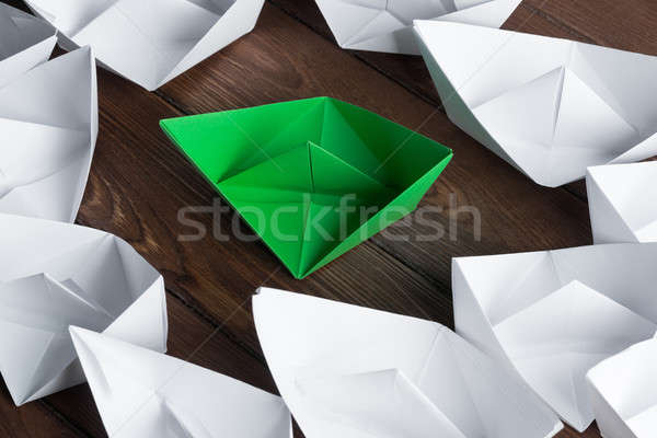 Business leadership concept with white and color paper boats on wooden table Stock photo © adam121