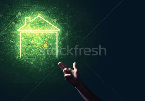 Conceptual image with hand pointing at house or main page icon o Stock photo © adam121