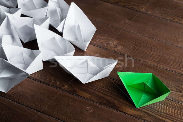 Business leadership concept with white and color paper boats on wooden table Stock photo © adam121