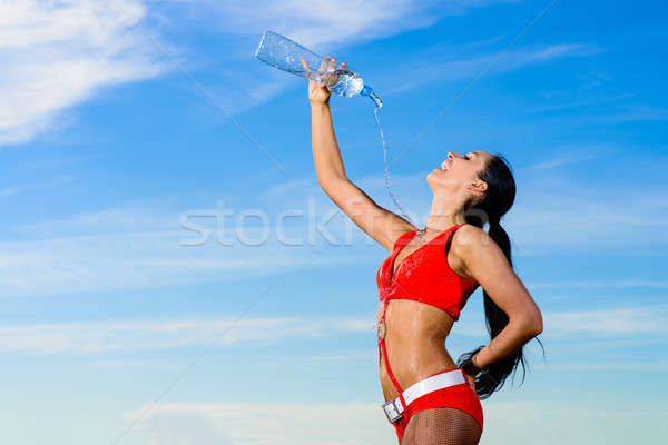 sport girl in red uniform with a bottle of water Stock photo © adam121