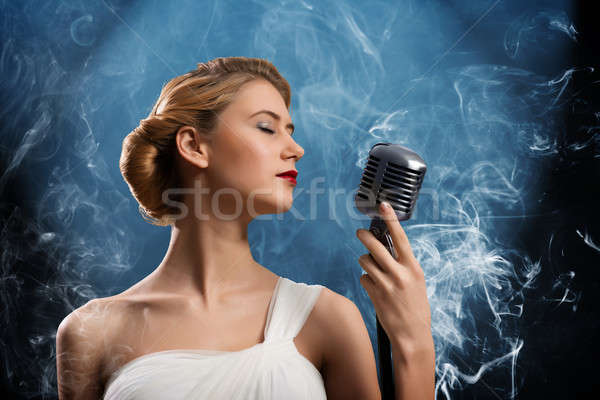 beautiful blonde woman singer with a microphone Stock photo © adam121