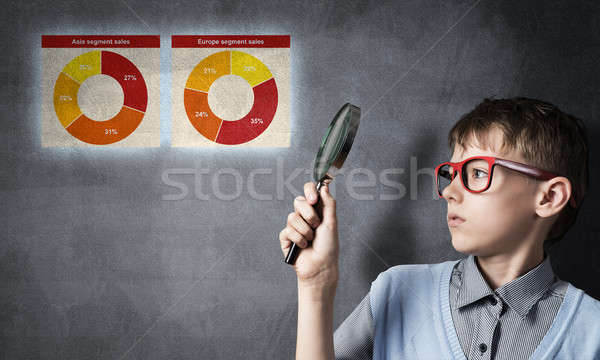 Stock photo: Curious school boy with magnifier