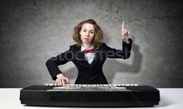 Mad woman play piano Stock photo © adam121