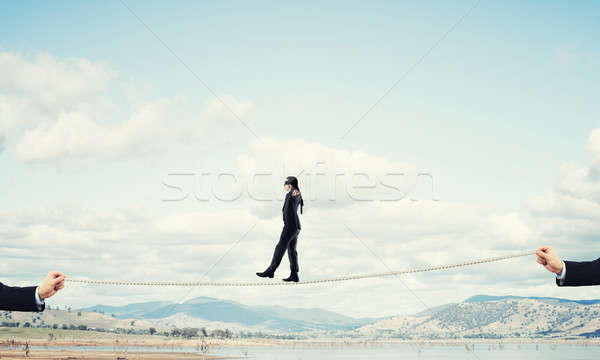 Stock photo: Business concept of risk support and assistance with man balanci