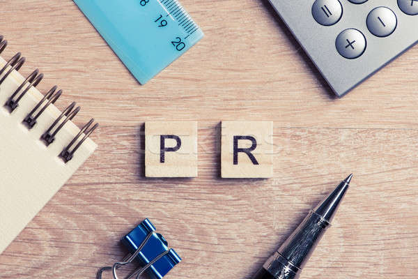 PR abbreviation on table spelled with education game elements Stock photo © adam121