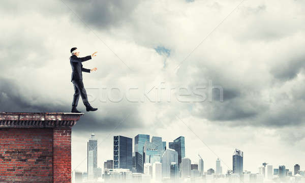 Danger and risk concept with businessman making step from edge Stock photo © adam121