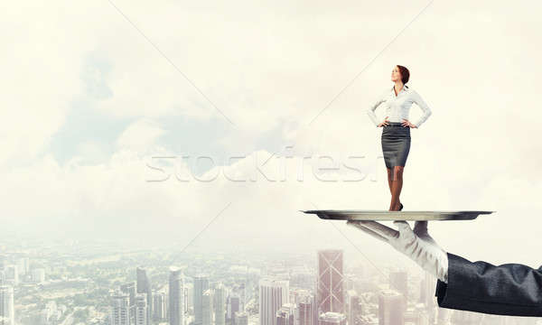 Confident elegant businesswoman presented on metal tray against  Stock photo © adam121