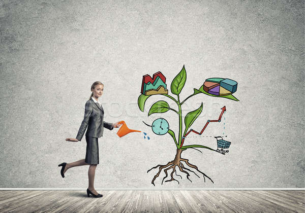 Young businesswoman in empty room watering drawn growth concept  Stock photo © adam121