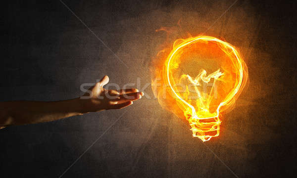 Concept of electricity or inspiration with burning light bulb and creation gesture Stock photo © adam121