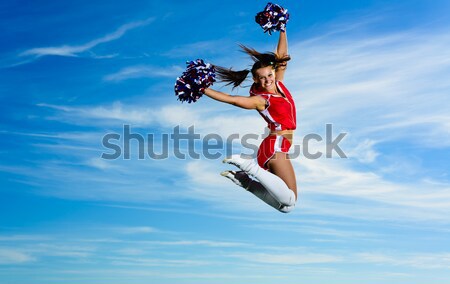 Jovem chefe de torcida vermelho traje saltando blue sky Foto stock © adam121