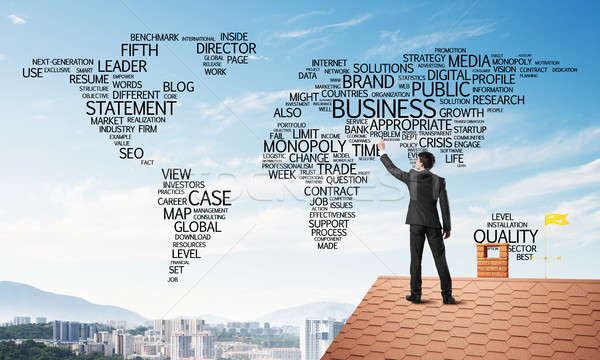 Businessman on brick roof draw world map as concept of globalization. Mixed media Stock photo © adam121