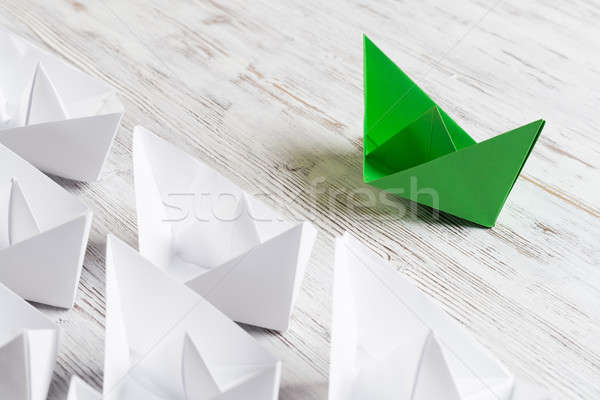 Business leadership concept with white and color paper boats on wooden table Stock photo © adam121