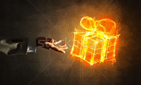 Concept of celebration with fire burning gift symbol and businessman palm Stock photo © adam121