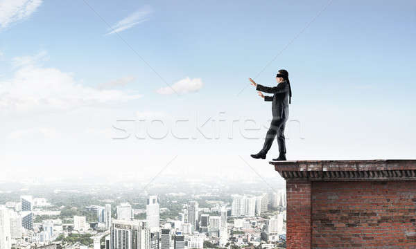 Danger and risk concept with businessman making step from edge Stock photo © adam121