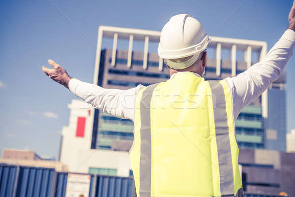 Senior foreman in glasses doing his job at building area on sunn Stock photo © adam121