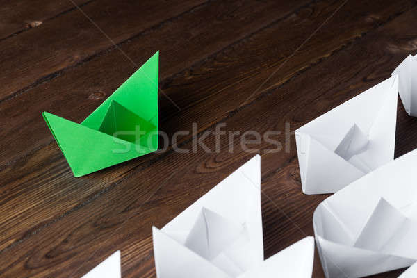 Business leadership concept with white and color paper boats on wooden table Stock photo © adam121