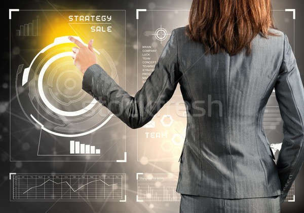 Businesswoman standing with back and pressing icon on media screen Stock photo © adam121