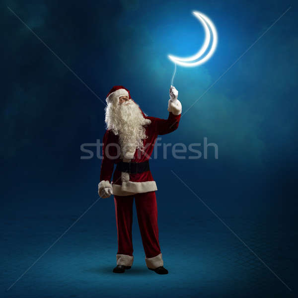 Santa Claus holding a shining moon Stock photo © adam121