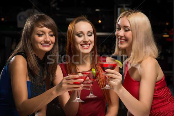 three girls raised their glasses in a nightclub Stock photo © adam121
