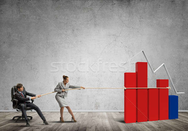 Businesspeople pulling with effort graph growth as a symbol of financial success Stock photo © adam121