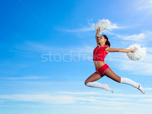 Jeunes cheerleader rouge costume sautant ciel bleu [[stock_photo]] © adam121