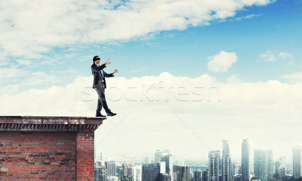 Danger and risk concept with businessman making step from edge Stock photo © adam121