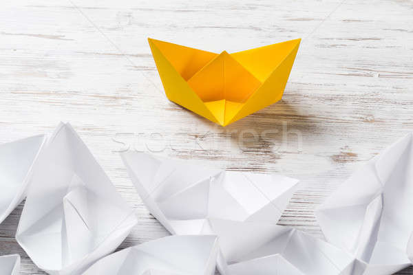 Business leadership concept with white and color paper boats on wooden table Stock photo © adam121