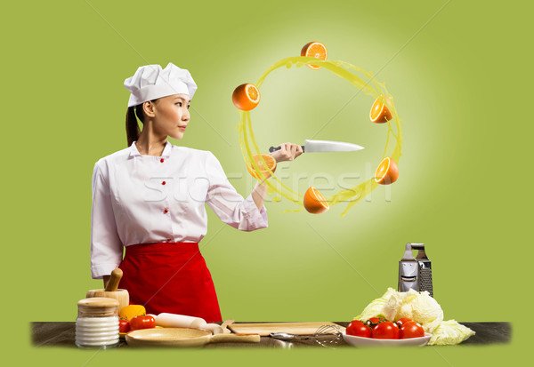 Asian female chef slicing oranges Stock photo © adam121