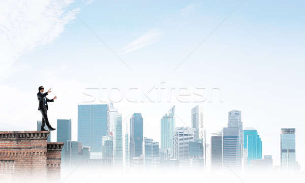 Danger and risk concept with businessman making step from edge Stock photo © adam121