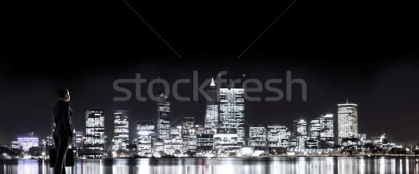 Businesswoman viewing night glowing city Stock photo © adam121