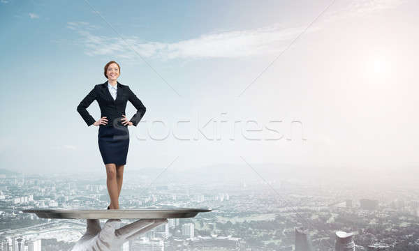 Confident elegant businesswoman presented on metal tray against cityscape background Stock photo © adam121