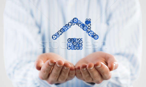 Symbol of homepage or accomodation made with cogwheels presented in male palms Stock photo © adam121