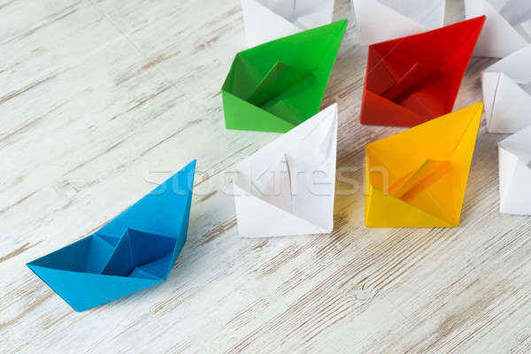 Business leadership concept with white and color paper boats on wooden table Stock photo © adam121