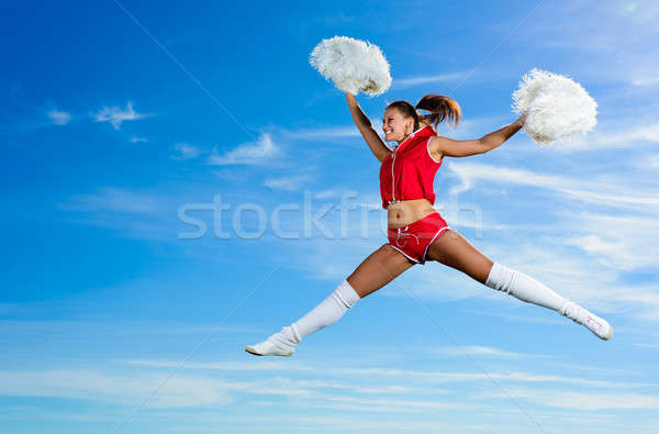 Jeunes cheerleader rouge costume sautant ciel bleu [[stock_photo]] © adam121