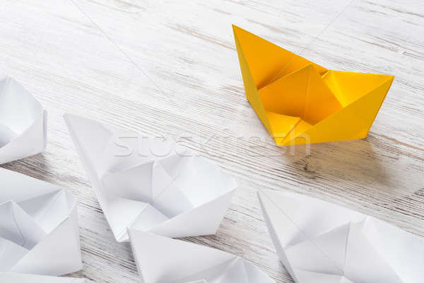 Business leadership concept with white and color paper boats on wooden table Stock photo © adam121