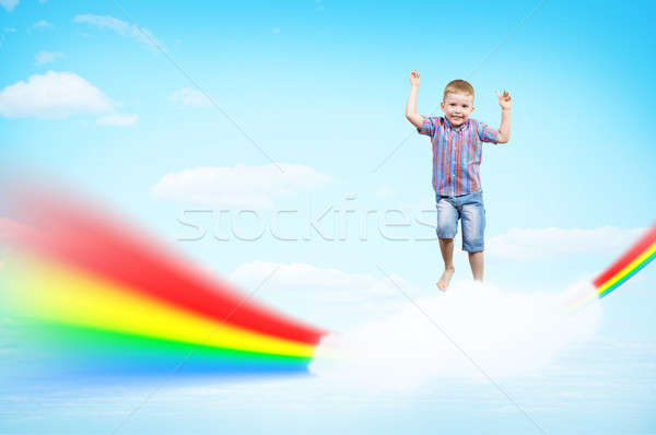 boy jumping on clouds and a rainbow Stock photo © adam121