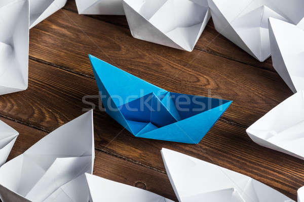 Business leadership concept with white and color paper boats on wooden table Stock photo © adam121