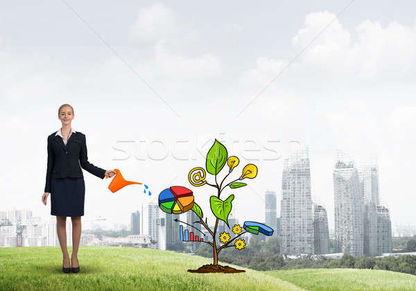 Young businesswoman outdoors watering drawn growth concept with can Stock photo © adam121