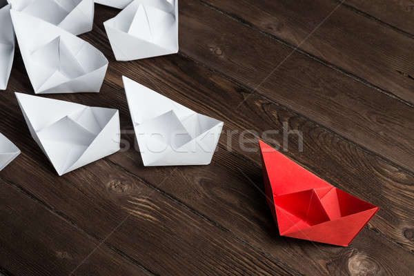 Business leadership concept with white and color paper boats on wooden table Stock photo © adam121