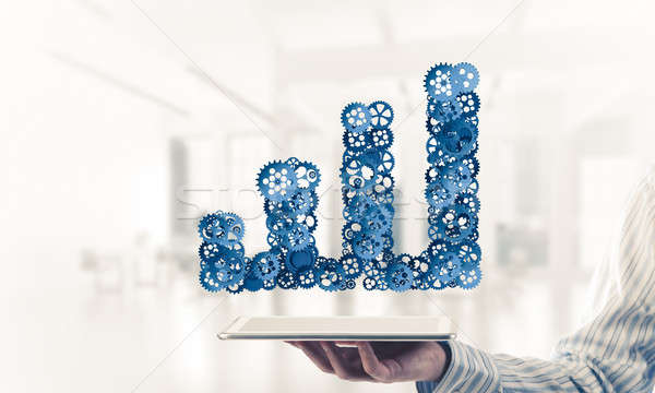 Close of businessman holding tablet pc with progressing graph ic Stock photo © adam121