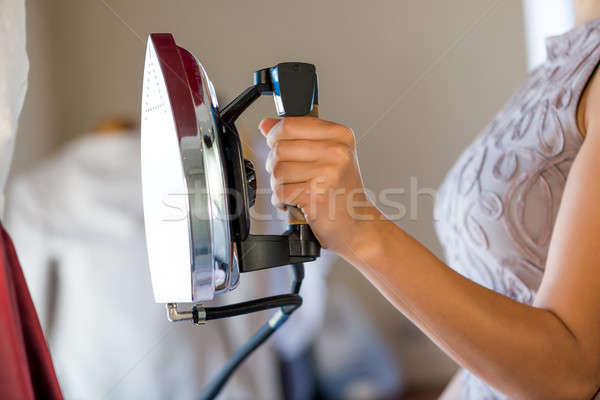 Woman holding iron Stock photo © adam121