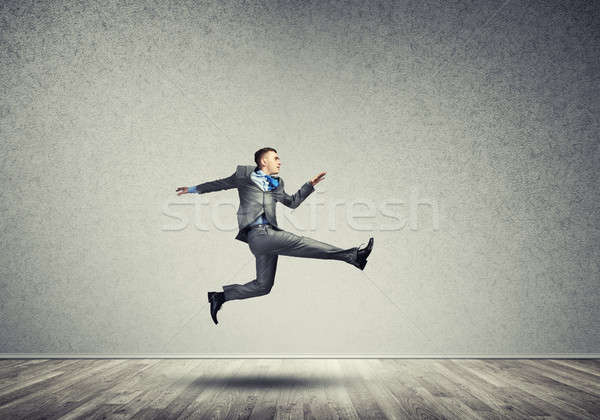 Empresário saltando alto jovem quarto corrida Foto stock © adam121