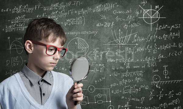 Curious school boy with magnifier Stock photo © adam121