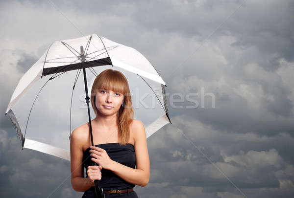 Stock photo: woman holding umbrella