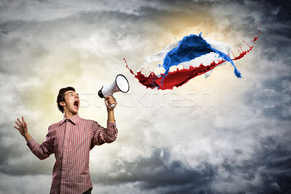 Portrait of a young man shouting using megaphone Stock photo © adam121
